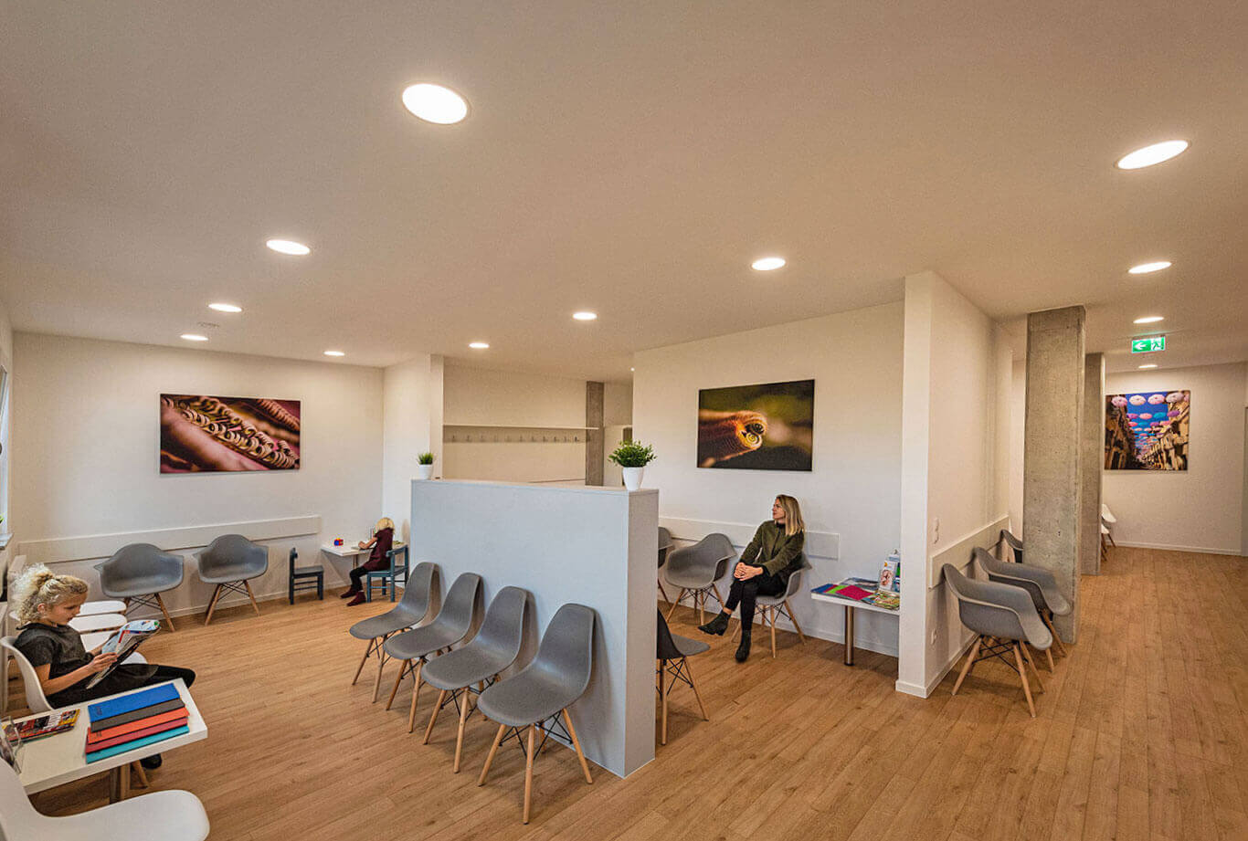 Three patients are waiting in the friendly, bright waiting area